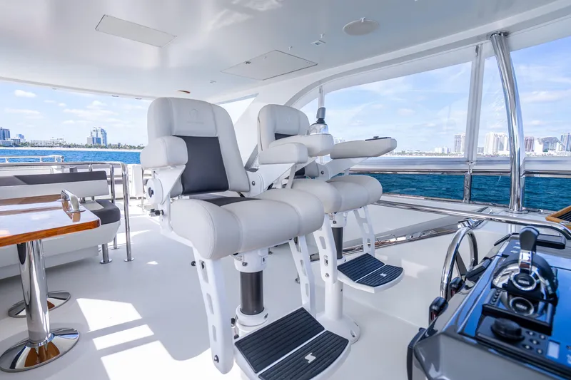 Slide: The Image of Luxurious 2021 Ocean Alexander 70E Motoryacht helm with plush seating and ocean view. - 19