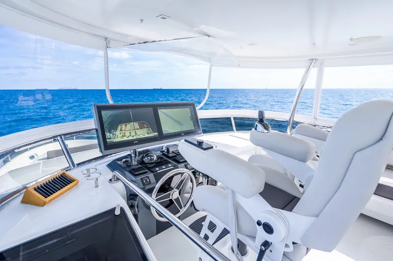 Slide: The Image of Cockpit of 2021 Ocean Alexander 70E Motoryacht with ocean view and navigation screens. - 23