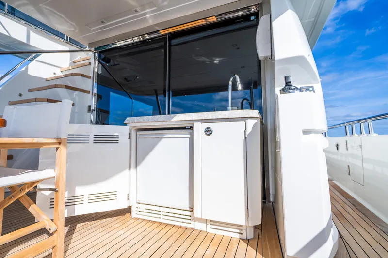 Slide: The Image of Luxurious Ocean Alexander 70E Motoryacht 2021 deck with outdoor kitchenette and seating. - 25