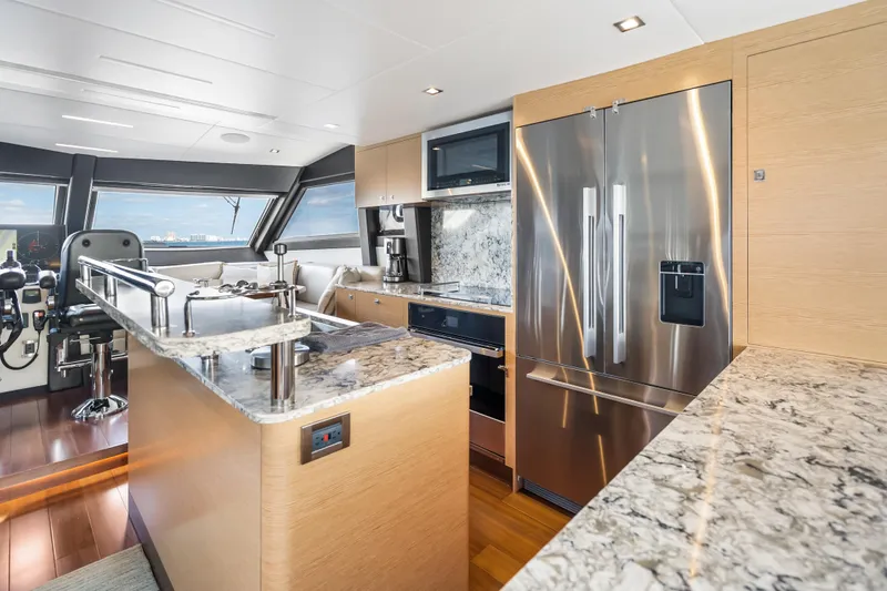 Slide: The Image of Luxurious kitchen interior of 2021 Ocean Alexander 70E Motoryacht with modern appliances and marble countertops. - 31