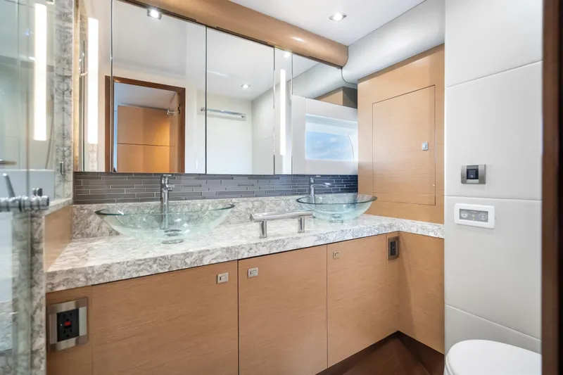 Slide: The Image of Luxurious bathroom in 2021 Ocean Alexander 70E Motoryacht with dual glass sinks and modern fixtures. - 44