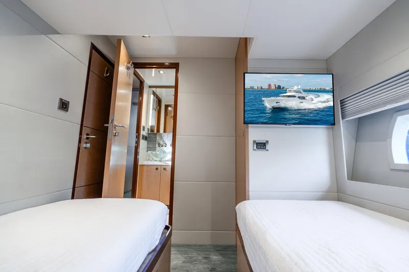 Slide: The Image of Luxurious cabin interior of 2021 Ocean Alexander 70E Motoryacht with twin beds and TV. - 52