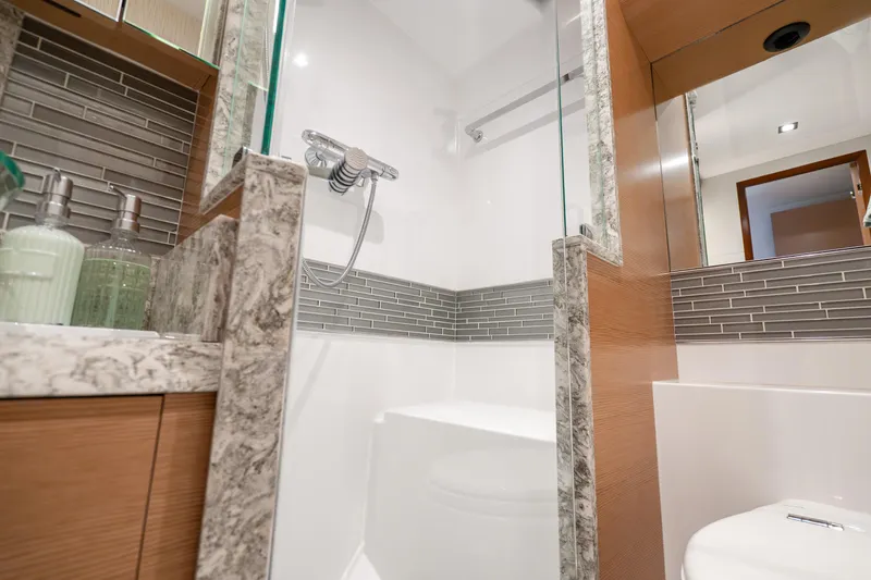 Slide: The Image of Luxurious bathroom in 2021 Ocean Alexander 70E Motoryacht with modern fixtures and elegant design. - 56