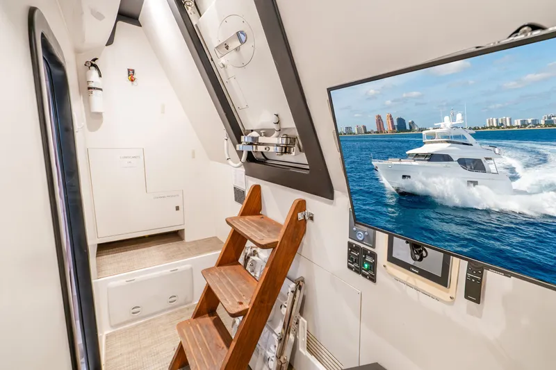 Slide: The Image of Interior of 2021 Ocean Alexander 70E Motoryacht with wooden ladder and wall-mounted screen. - 57