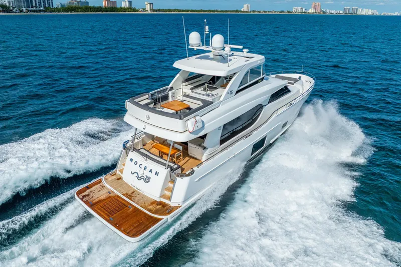 Slide: The Image of 2021 Ocean Alexander 70E Motoryacht cruising on blue ocean near city skyline. - 9