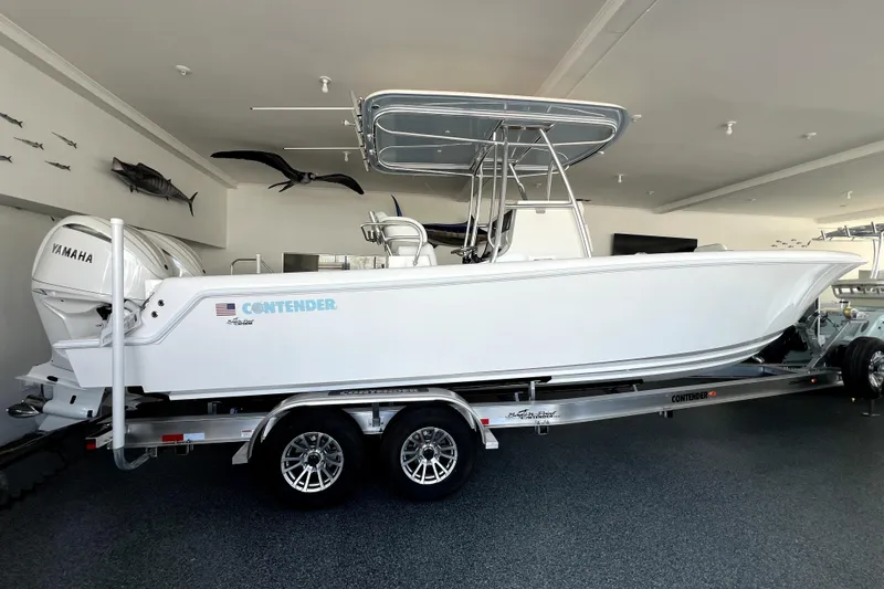 The Image of 2026 Contender boat on trailer in showroom with Yamaha engine. - 0