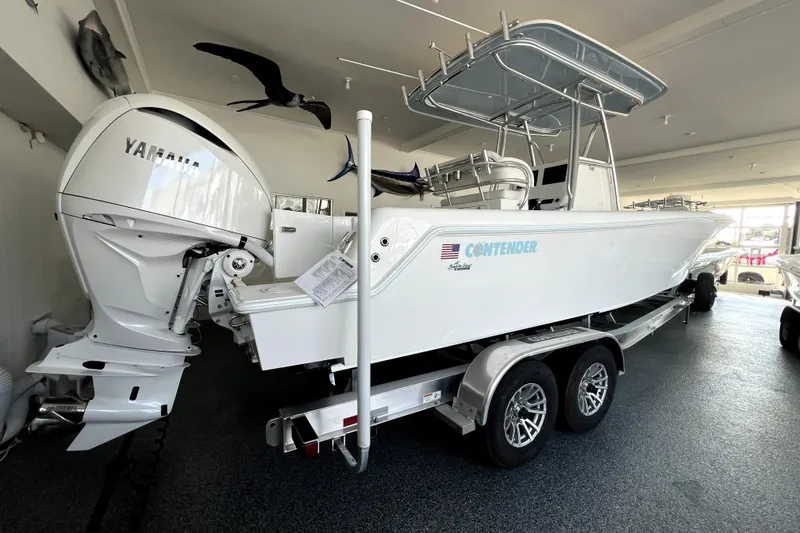 Slide: The Image of 2026 Contender boat with Yamaha engine on trailer in showroom. - 1