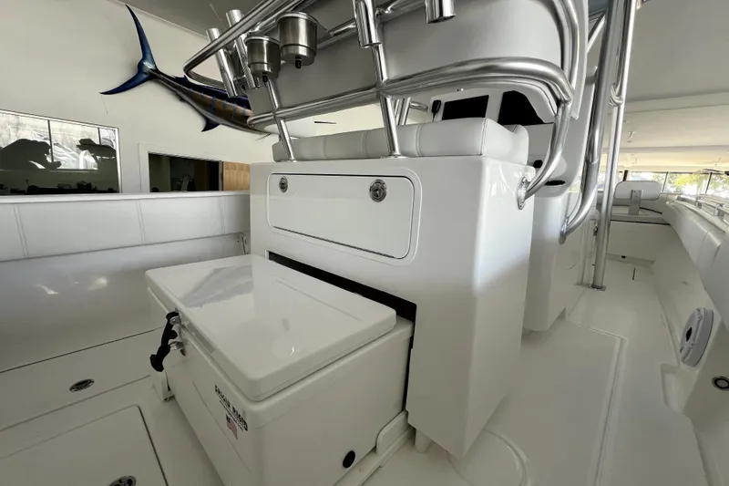 Slide: The Image of 2026 Contender boat interior with seating, storage, and fishing rod holders. - 12