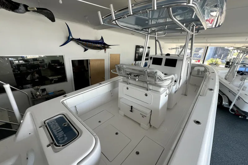 Slide: The Image of 2026 Contender boat interior with helm station, rod holders, and mounted fish decor. - 14