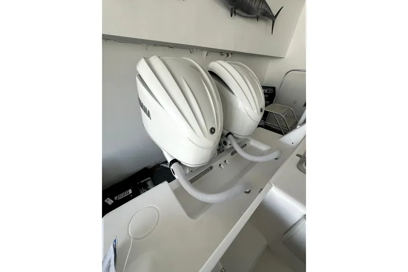 Slide: The Image of Twin outboard motors on a Contender boat, 2026 model, in a showroom setting. - 15