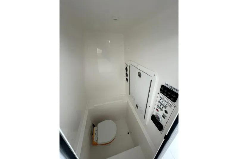 Slide: The Image of Compact marine bathroom with toilet and control panel, Contender 2026 model. - 9