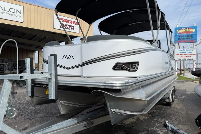Slide: The Image of 2026 Avalon LSZ Versatile Rear Bench Windshield pontoon boat on trailer at dealership. - 10