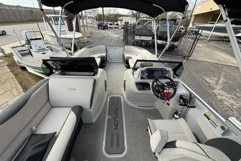 Slide: The Image of 2026 Avalon LSZ Versatile Rear Bench Windshield boat interior with modern seating and steering console. - 21