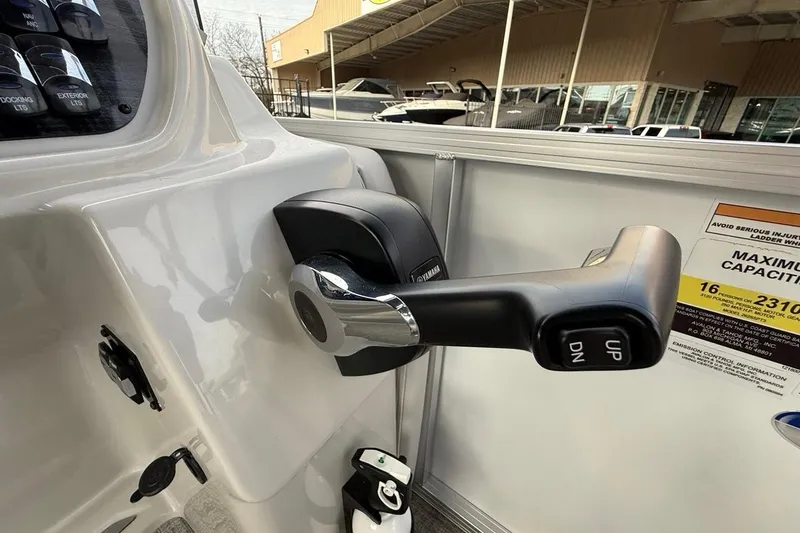 Slide: The Image of Close-up of 2026 Avalon LSZ Versatile boat control lever with "UP" and "DN" buttons. - 28