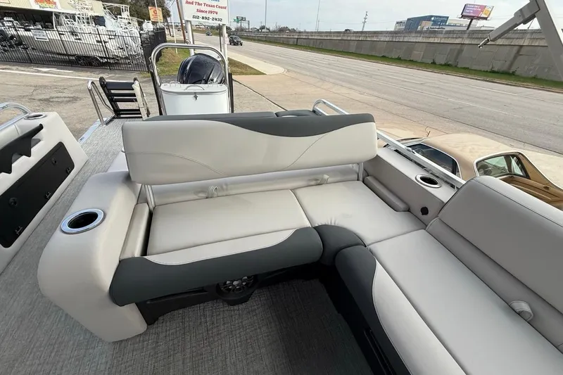 Slide: The Image of 2026 Avalon LSZ Versatile Rear Bench Windshield boat interior with plush seating and cup holders. - 34
