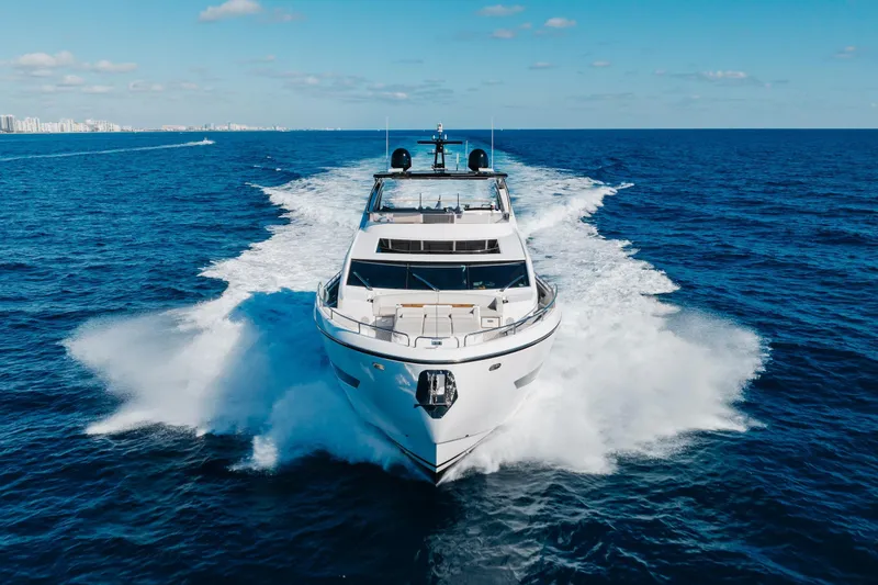 Slide: The Image of 2023 Sunseeker 90 Ocean yacht cruising on open sea under clear blue sky. - 2