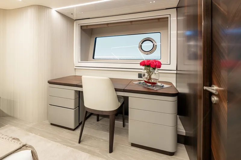 Slide: The Image of Luxurious interior of 2023 Sunseeker 90 Ocean yacht with elegant desk and window view. - 25