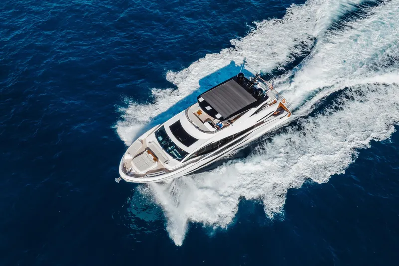 Slide: The Image of 2023 Sunseeker 90 Ocean yacht cruising on open blue sea, aerial view. - 3