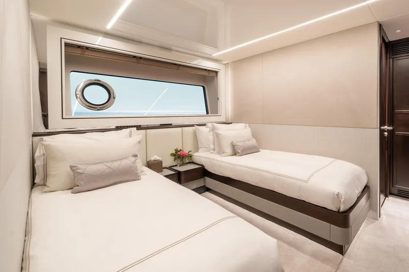 Slide: The Image of Luxurious twin cabin interior on 2023 Sunseeker 90 Ocean yacht, featuring elegant bedding and ocean view. - 32