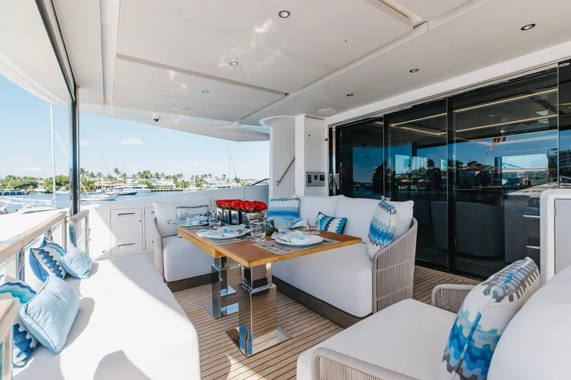 Slide: The Image of Luxurious 2023 Sunseeker 90 Ocean yacht deck with elegant dining setup and scenic marina view. - 8