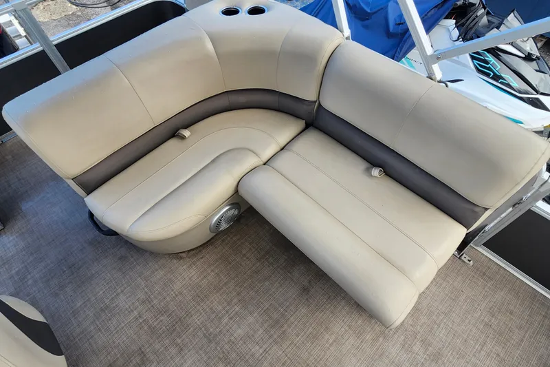 Slide: The Image of 2023 Sun Tracker Party Barge 18 DLX, beige seating with cup holders and speaker. - 10