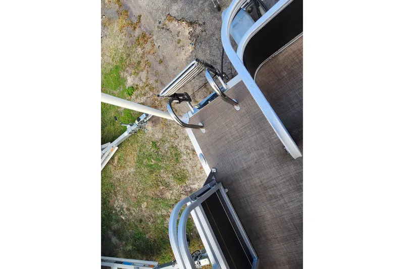 Slide: The Image of 2023 Sun Tracker Party Barge 18 DLX deck with ladder, viewed from above. - 14