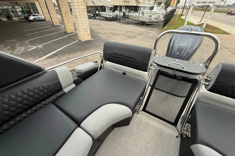 Slide: The Image of Luxurious 2026 Avalon Excalibur LTD Quad Lounger Shift boat interior with sleek black seating. - 19