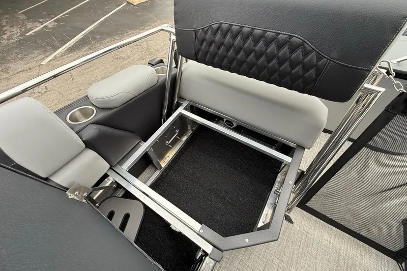 Slide: The Image of 2026 Avalon Excalibur LTD Quad Lounger Shift with open storage compartment and cup holders. - 20