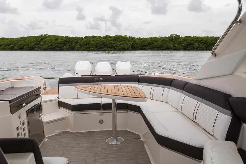 Slide: The Image of 2018 Sea Ray SLX 350 Outboard boat on open water, featuring luxurious seating and sleek design. - 13