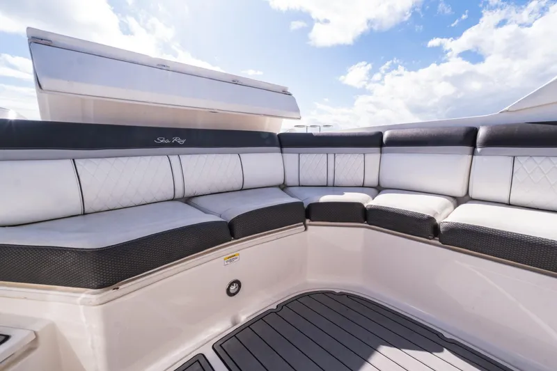 Slide: The Image of Luxurious seating on 2018 Sea Ray SLX 350 Outboard boat under blue sky. - 19