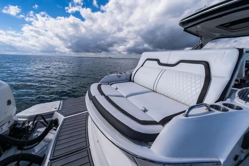 Slide: The Image of 2018 Sea Ray SLX 350 Outboard boat with luxurious seating on open water. - 21