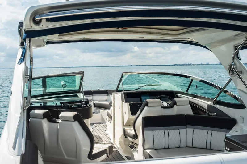 Slide: The Image of 2018 Sea Ray SLX 350 Outboard boat interior with luxurious seating on open water. - 22