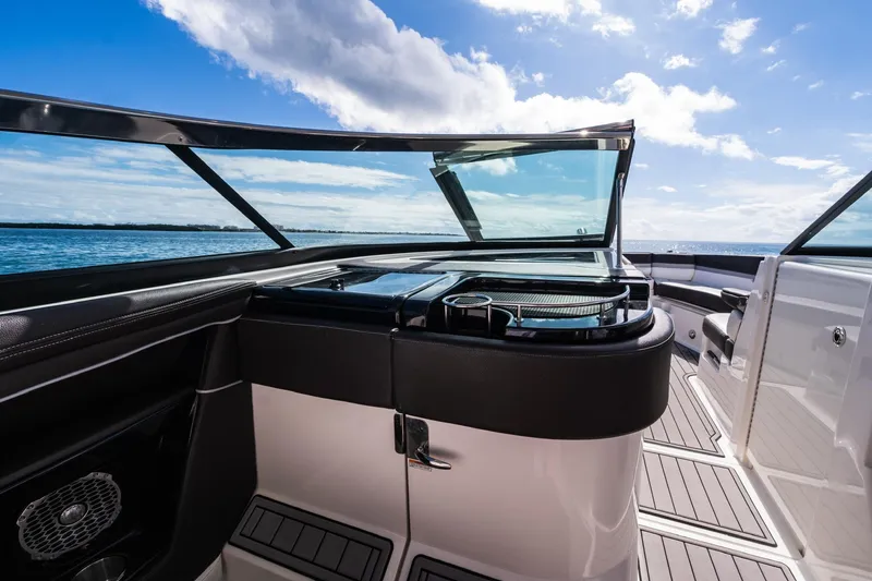 Slide: The Image of 2018 Sea Ray SLX 350 Outboard boat interior with sleek design and ocean view. - 25