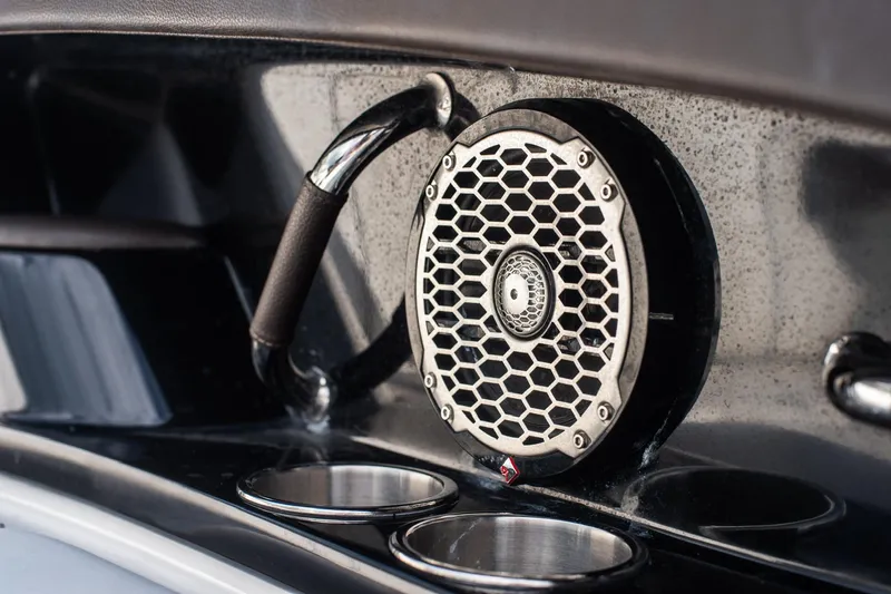 Slide: The Image of Speaker and cup holders on 2018 Sea Ray SLX 350 Outboard boat interior. - 27