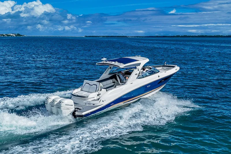 Slide: The Image of 2018 Sea Ray SLX 350 Outboard cruising on open blue waters. - 3