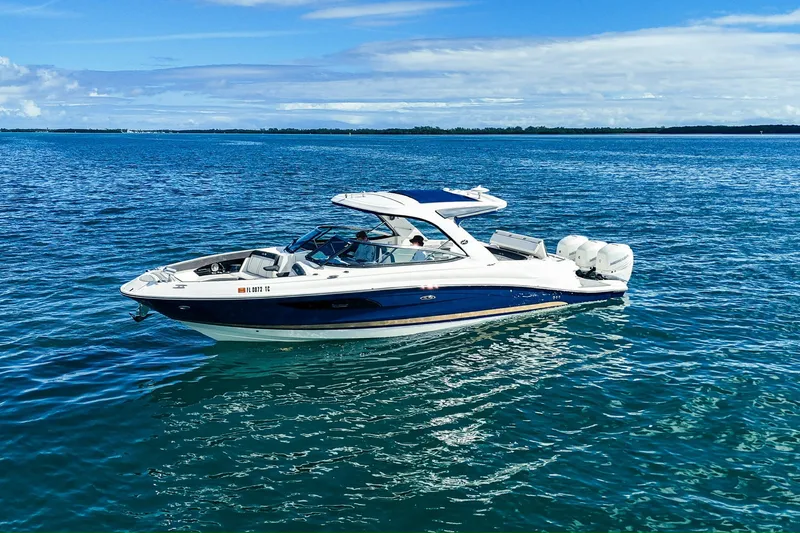 Slide: The Image of 2018 Sea Ray SLX 350 Outboard cruising on clear blue water. - 6