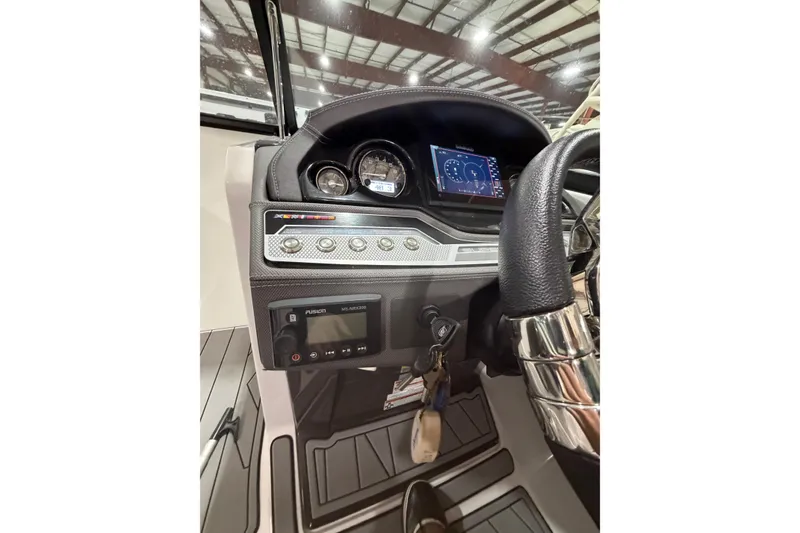Slide: The Image of 2023 Monterey 255SS Super Sport dashboard with gauges and controls in a boat interior. - 14