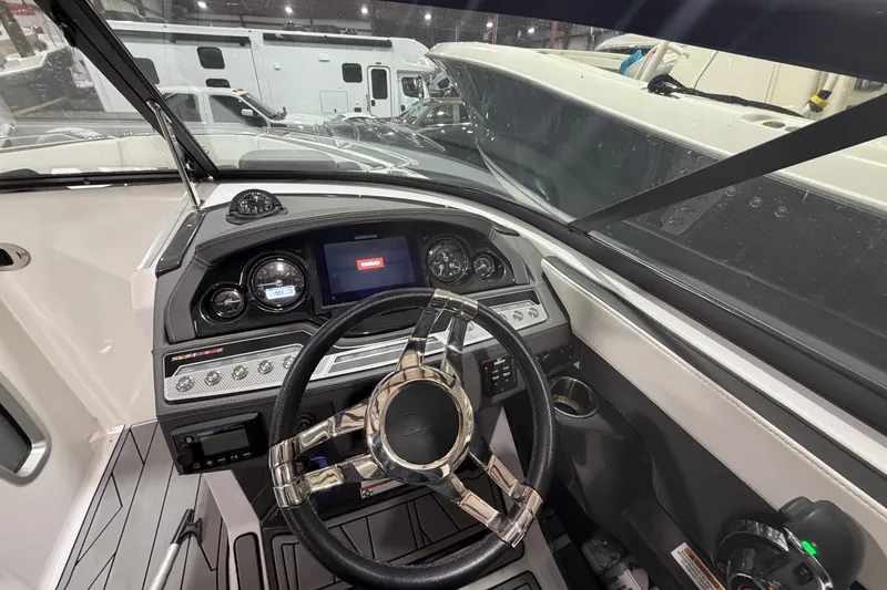 Slide: The Image of 2023 Monterey 255SS Super Sport boat dashboard with modern controls and steering wheel. - 15