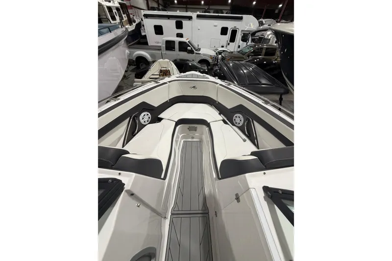 Slide: The Image of 2023 Monterey 255SS Super Sport boat interior with seating and speakers in showroom. - 19