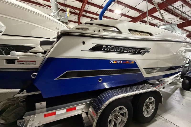 Slide: The Image of 2023 Monterey 255SS Super Sport boat on trailer in indoor storage facility. - 2