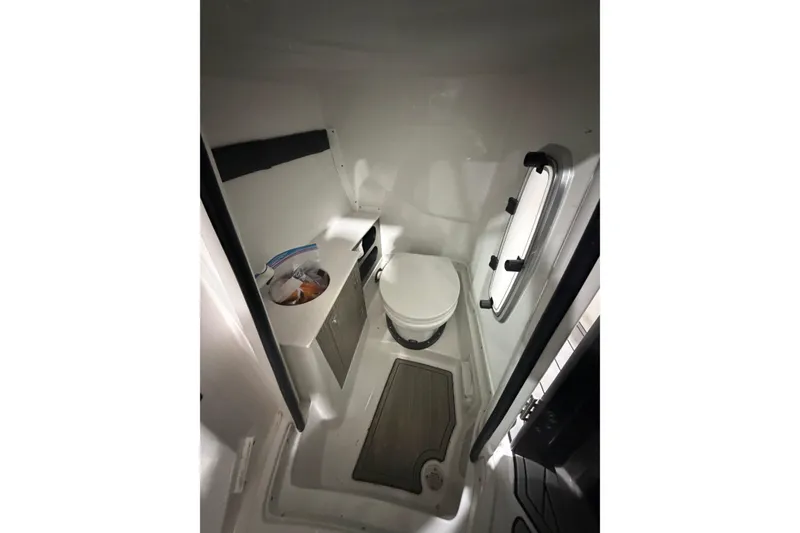 Slide: The Image of 2023 Monterey 255SS Super Sport boat interior bathroom with toilet and window. - 22