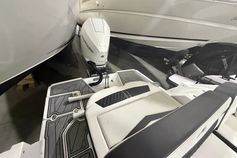 Slide: The Image of 2023 Monterey 255SS Super Sport boat with Mercury outboard engine, docked indoors. - 6