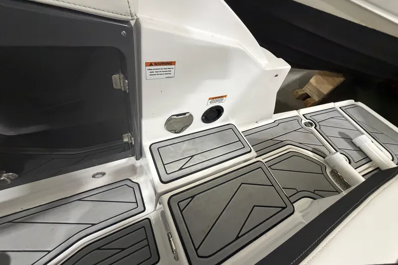 Slide: The Image of 2023 Monterey 255SS Super Sport boat interior with sleek, modern flooring and storage compartments. - 7