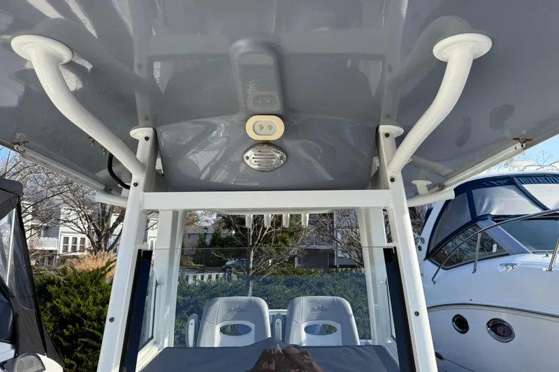 Slide: The Image of 2021 NauticStar 28 XS boat interior with T-top and seating. - 15