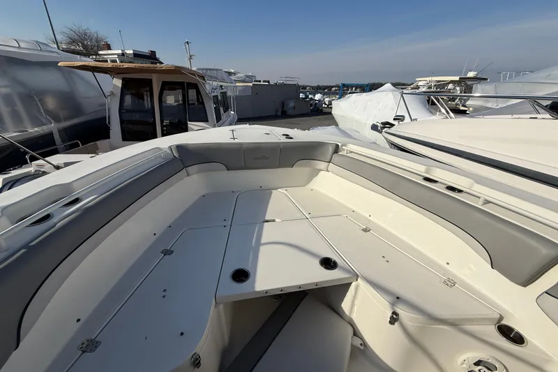 Slide: The Image of 2021 NauticStar 28 XS boat interior with spacious seating and storage compartments. - 17