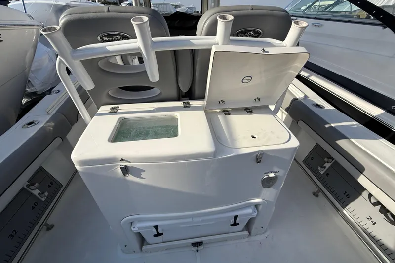 Slide: The Image of 2021 NauticStar 28 XS boat interior with storage compartments and rod holders. - 19