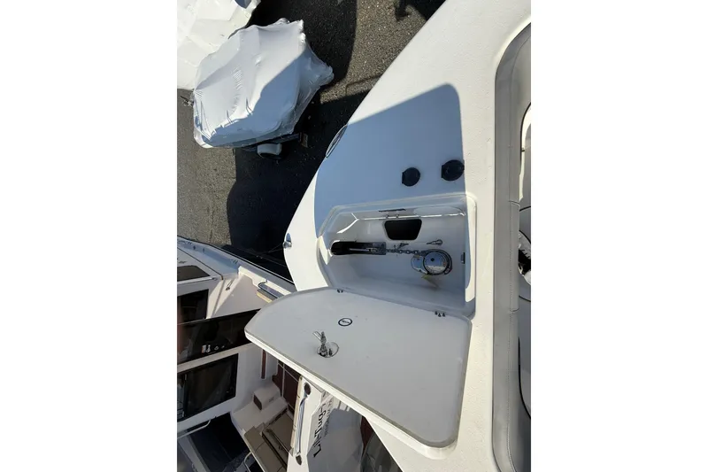 Slide: The Image of 2021 NauticStar 28 XS boat deck with open storage compartment. - 9