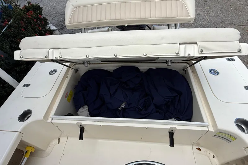 Slide: The Image of Open storage compartment on a 2006 Scout 170 Costa boat with blue fabric inside. - 11