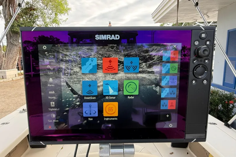 Slide: The Image of Simrad navigation display on 2006 Scout 170 Costa boat, featuring various marine functions. - 16