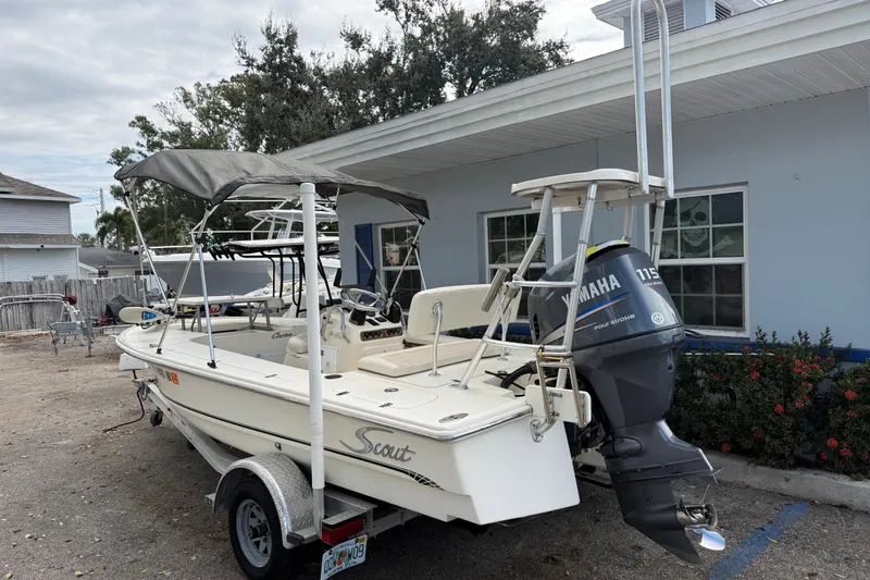 Slide: The Image of 2006 Scout 170 Costa boat with Yamaha 115 engine, parked outdoors. - 2